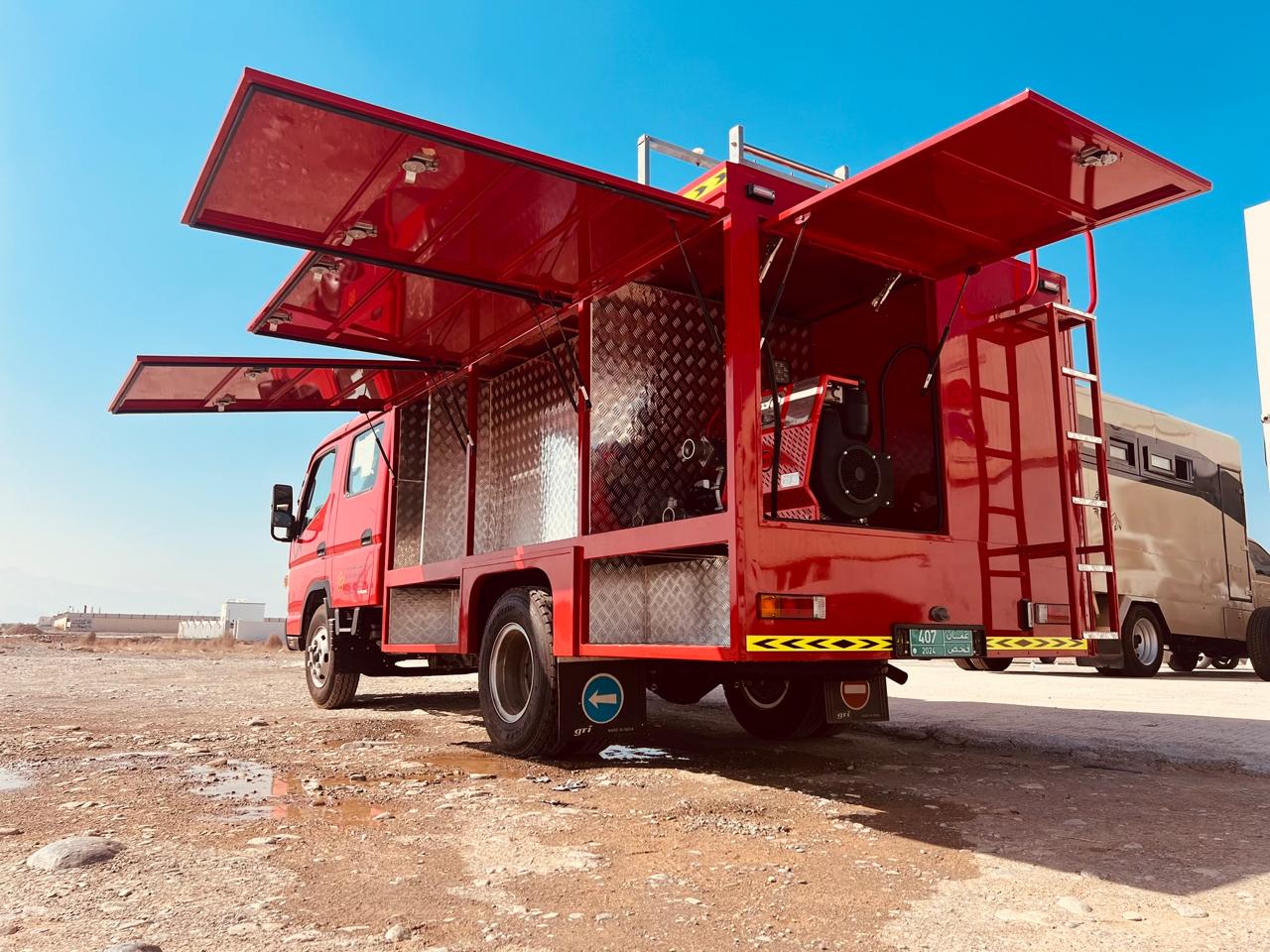 Fire & rescue truck with open gull-wing equipment lockers